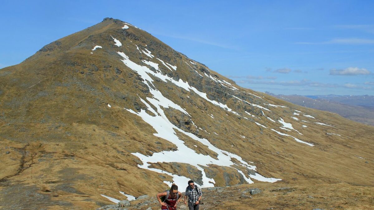 Hikers and snow on Ben More