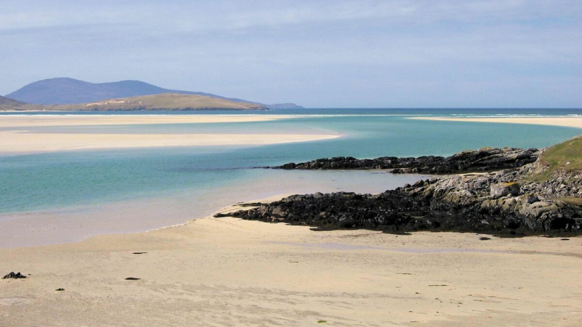Pristine sand and blue waters of the Luskentyre beach in Scotland