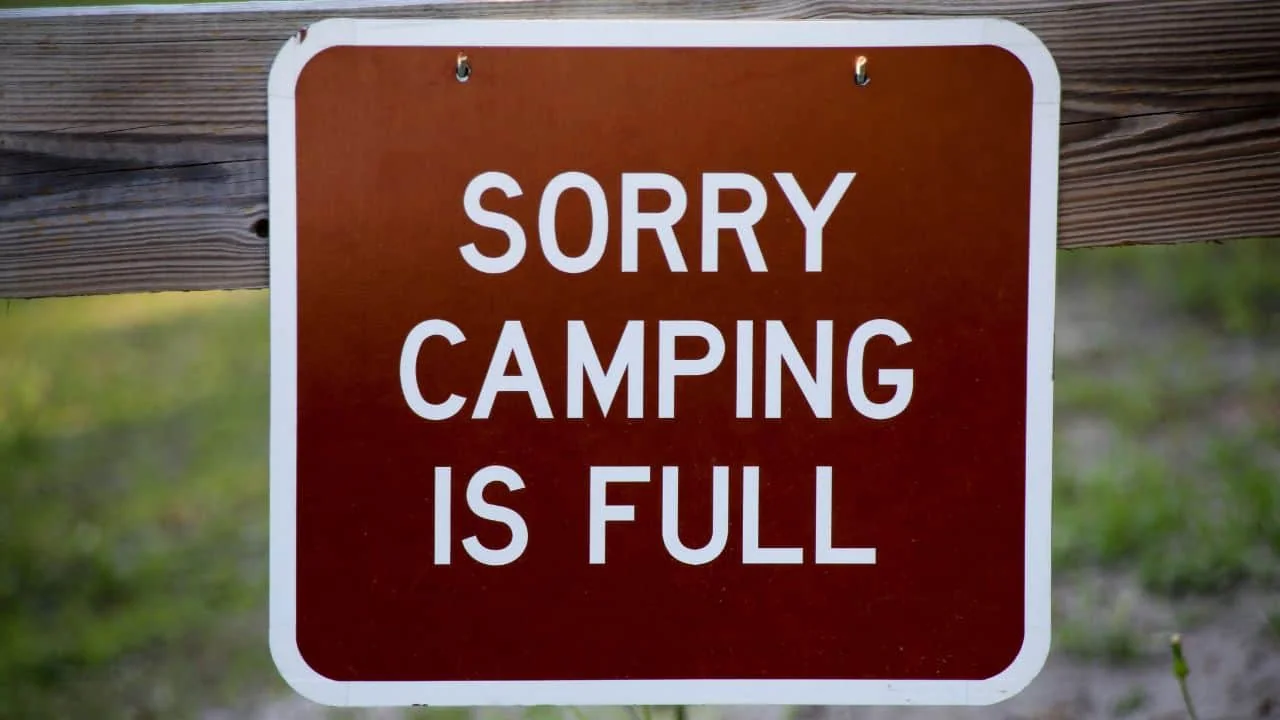 "Sorry Camping is Full" sign in a forest