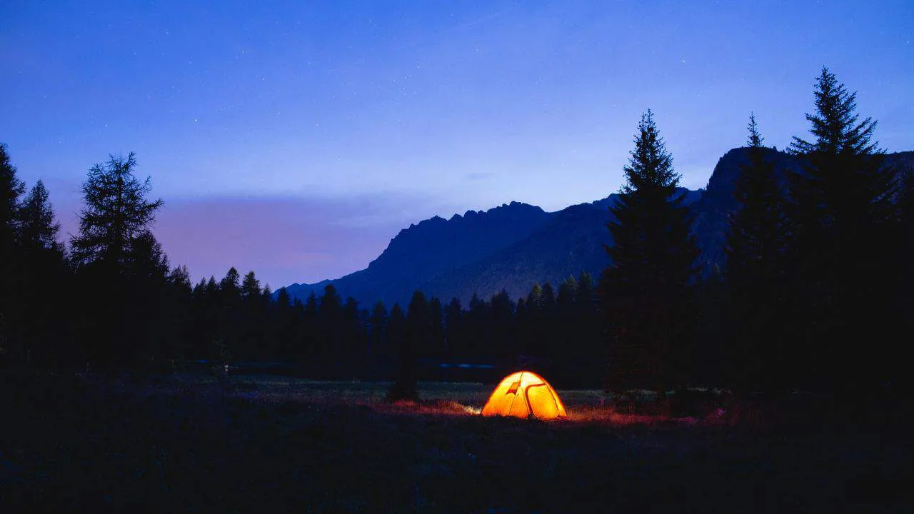 Wild camping tent pitched at night