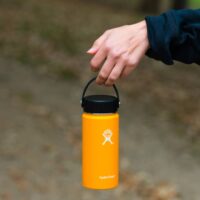 Hiker holding a hydro flask bottle