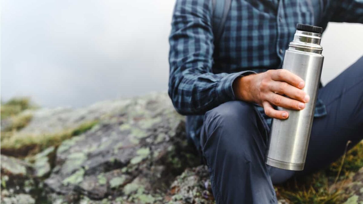 Hiker holding a Thermos bottle