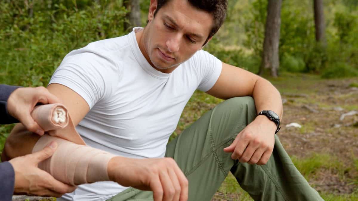 Hiker applying a bandage