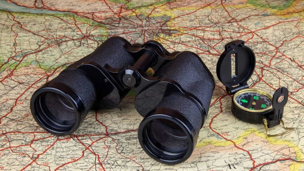 Binoculars and compass on a map of Scottland
